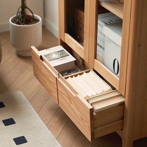 a wooden cabinet with drawers filled with books