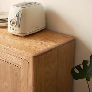 a toaster sitting on top of a wooden cabinet