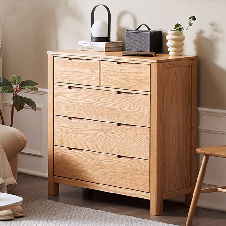 a wooden chest of drawers in a living room