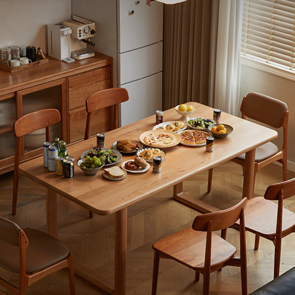 Ancona solid cherry wood dining table with rectangular legs and rounded corners in a warm family dining space