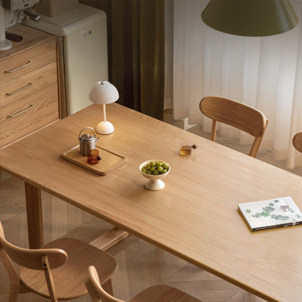 Ancona natural solid oak dining table with rectangular legs and rounded corners in a modern dining room.