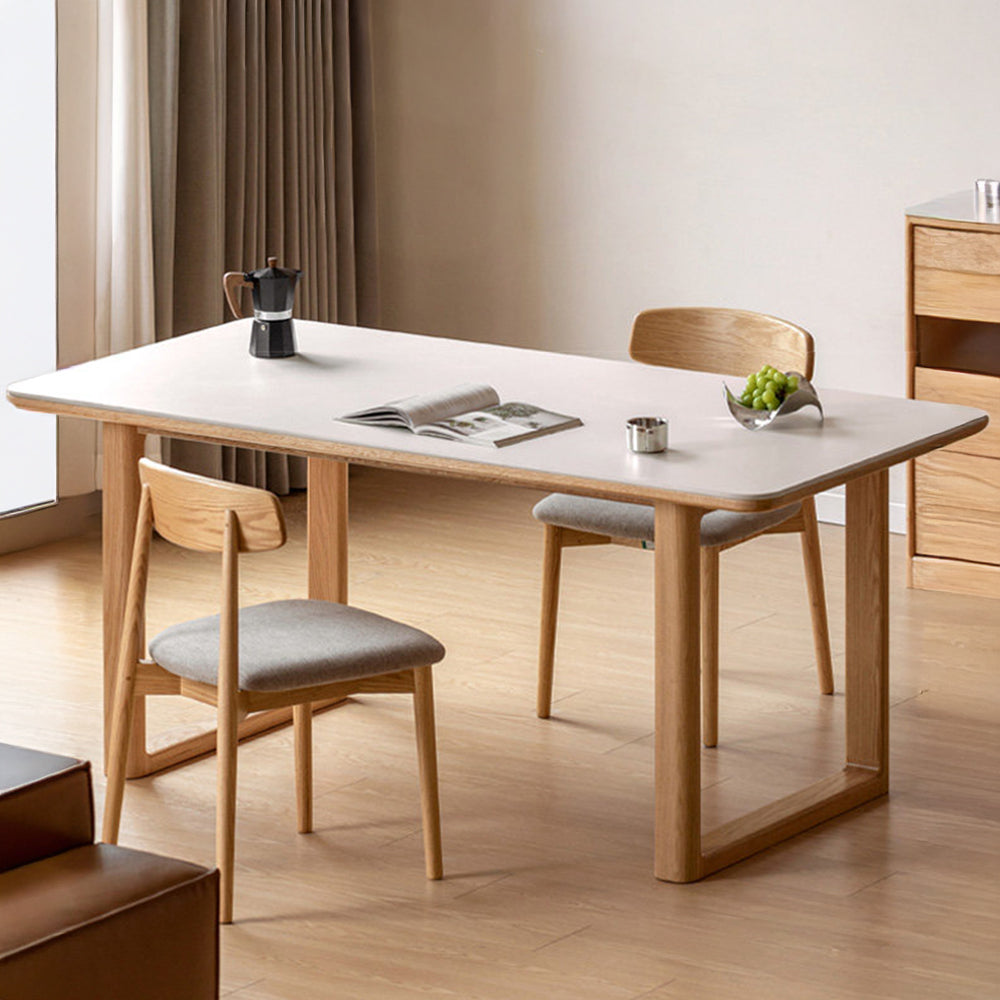 Ancona solid oak dining table with white ceramic top, rectangular legs and rounded corners in a modern dining room.