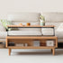 Anzio natural solid oak lift-top coffee table with hidden storage compartment and glass sliding door shelf in a modern living room