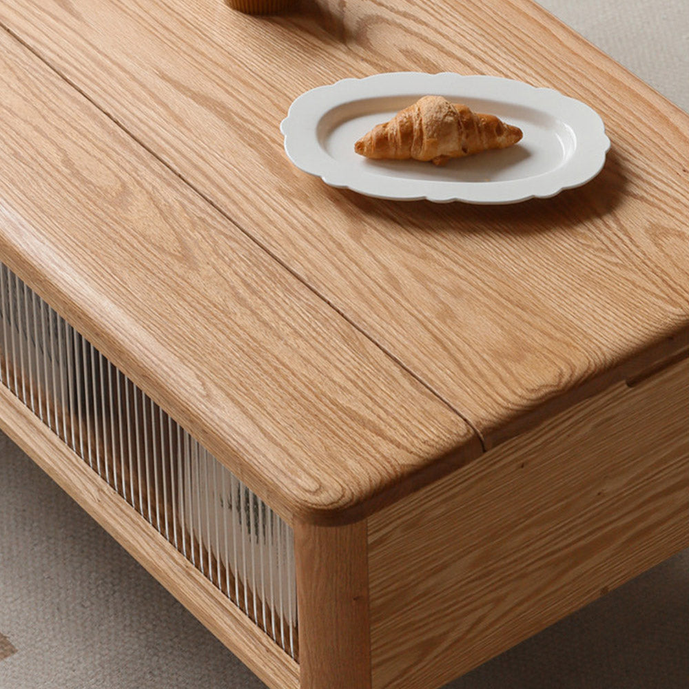 Anzio natural solid oak lift-top coffee table with hidden storage compartment and glass sliding door shelf in a modern living room