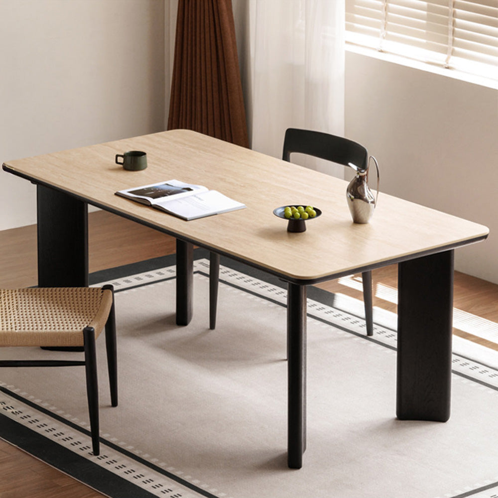 Bremen charcoal solid oak dining table with travertine-look sintered stone top in a modern dining room.