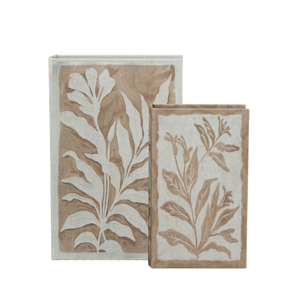 Set of two beige and brown decorative book boxes with botanical leaf print covers
