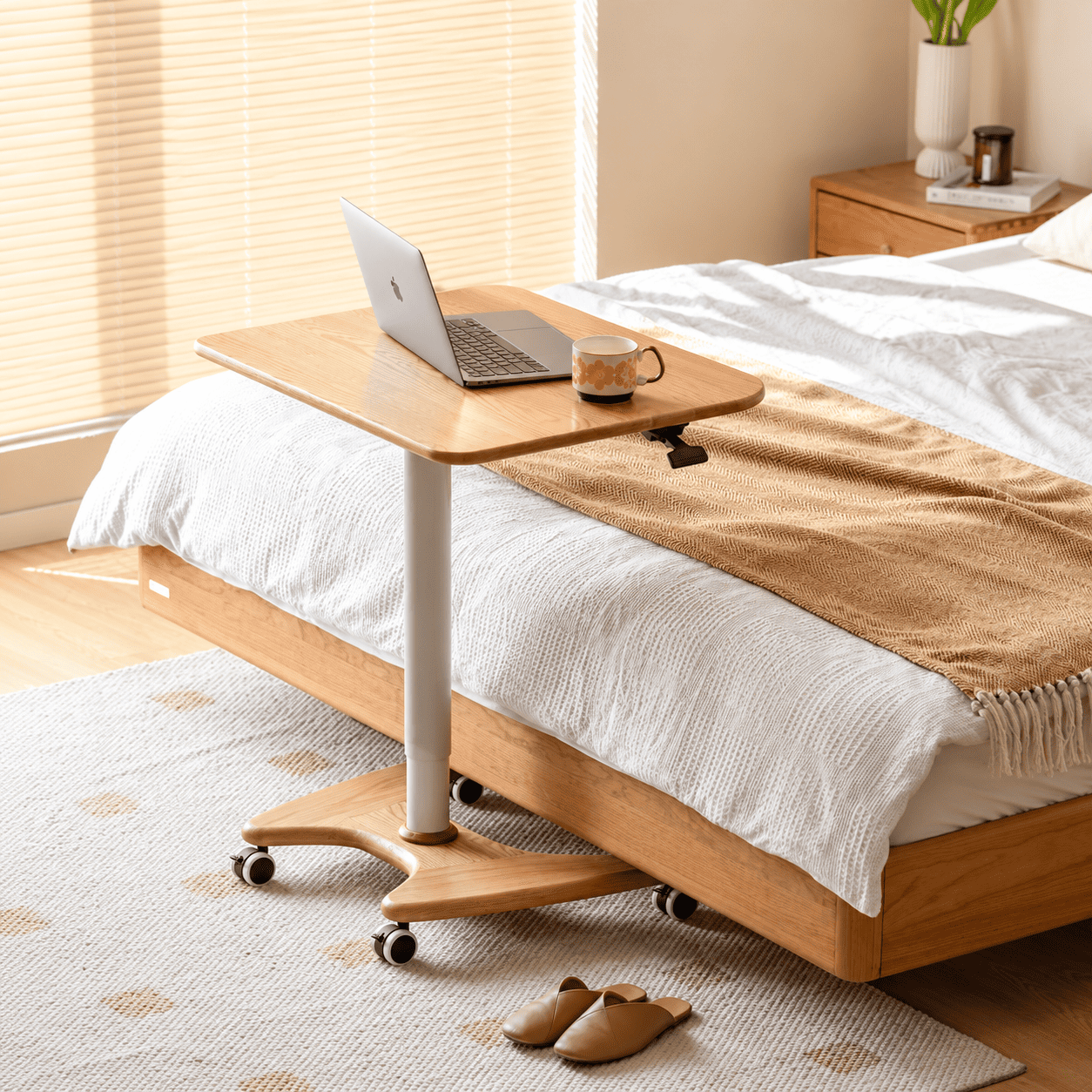 Cary natural solid oak movable small desk used beside a bed with laptop and mug