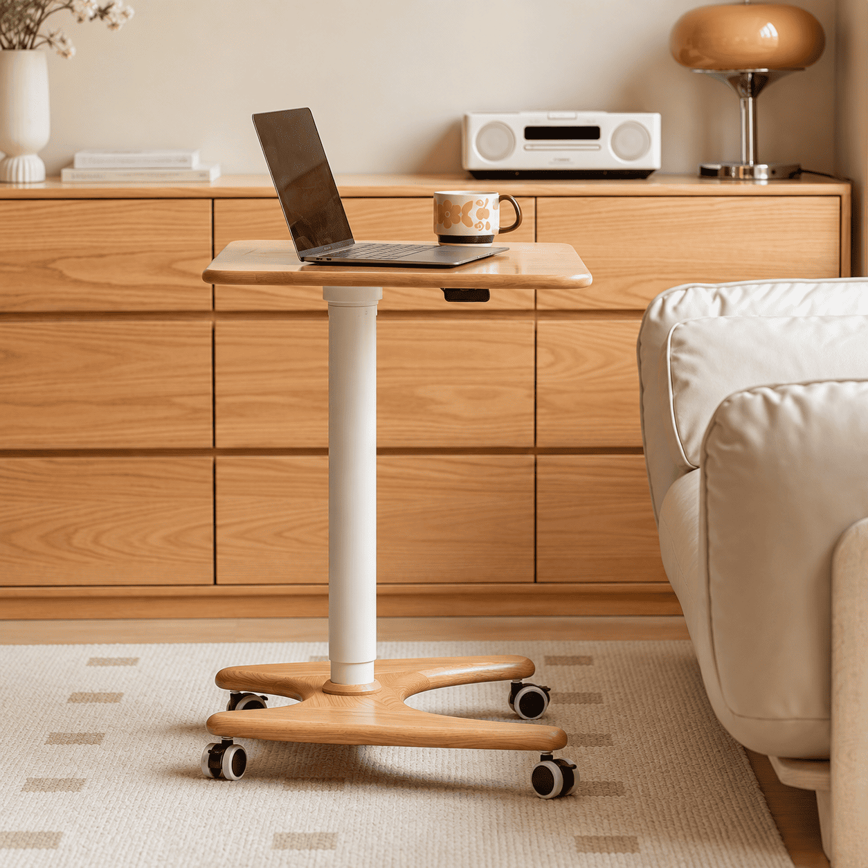 Cary solid oak movable small desk with laptop and mug in a bright living room setting