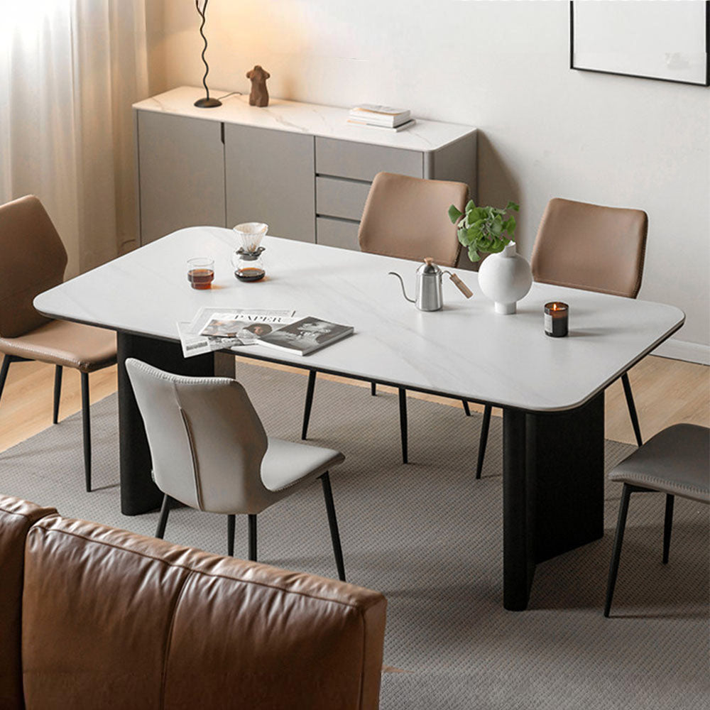 Charcoal solid oak dining table with white marble-look ceramic top and black pedestal legs, styled with dining chairs in a modern dining room.