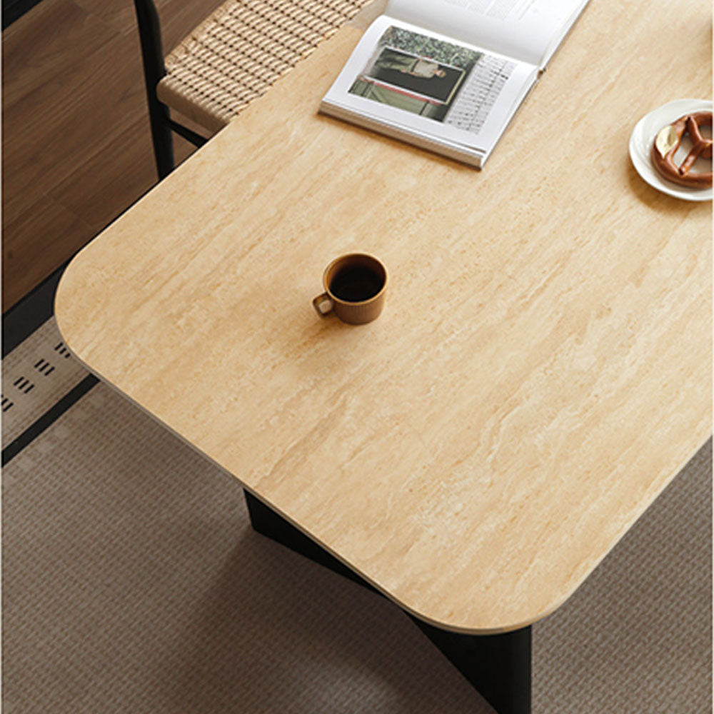 Charcoal solid oak dining table with travertine-look ceramic top and mid-century dot-detail legs, styled with dining chairs in a modern dining room.