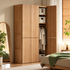 Clovis natural solid oak wardrobe with one door open showing hanging rail and storage shelves