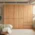 Clovis natural solid oak modular wardrobe closed across bedroom wall