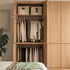 Clovis natural oak wardrobe open with upper shelf, hanging rail and lower storage section
