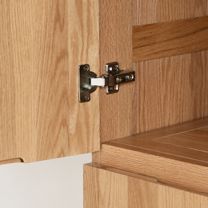 Close-up of Clovis natural solid oak wardrobe hinge and interior joinery detail