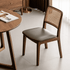 Ely walnut dining chair with refined timber frame and comfortable leather cushion pad