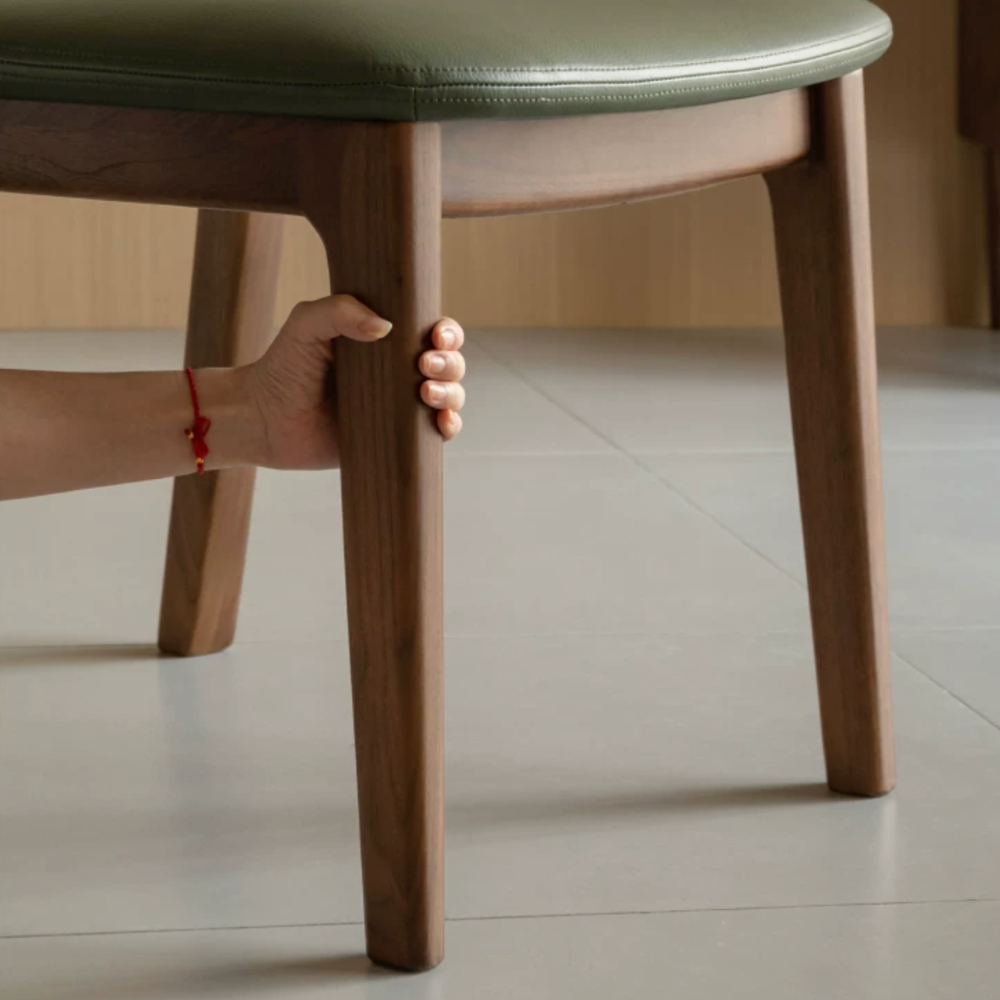 Natural solid walnut dining chair with cushioned leather pad and curved timber backrest