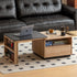 Empoli natural solid ash nesting coffee table set with black ceramic top, storage drawer, pegboard side and removable wheels in a living room