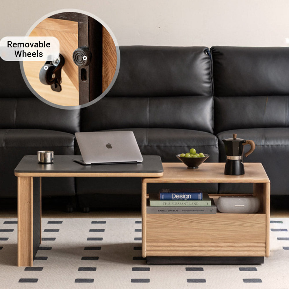 Empoli natural solid ash nesting coffee table set with black ceramic top, storage drawer, pegboard side and removable wheels in a living room