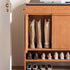 Enna natural solid cherry shoe cabinet with drawers, adjustable shoe racks, open shelves and side hooks in a hallway setting