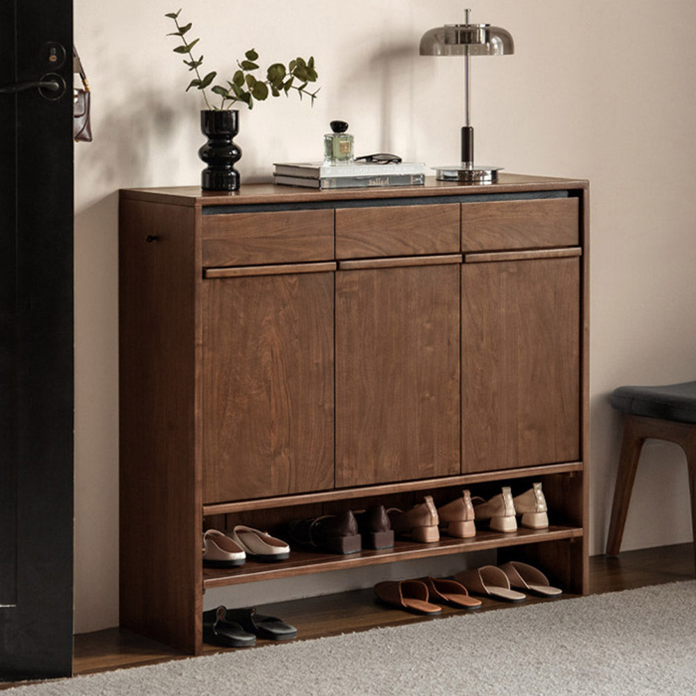 Enna natural solid walnut shoe cabinet with drawers, adjustable internal shoe racks, open shelves and side hooks in an entryway