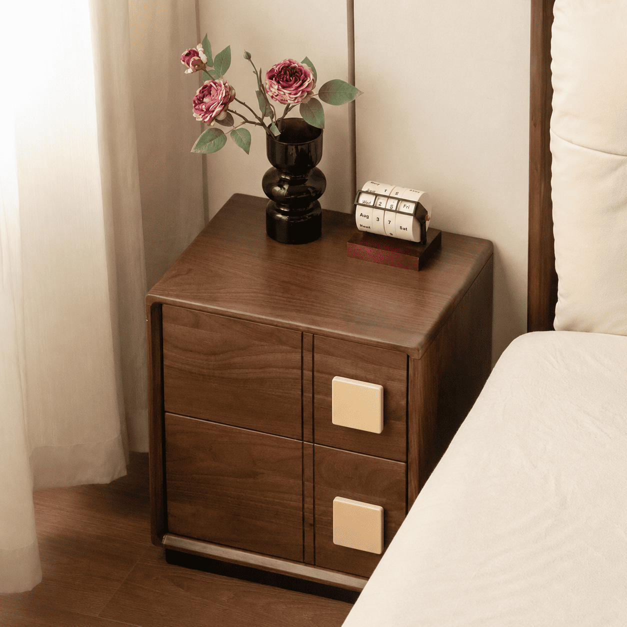 Fontana walnut bedside table with two drawers, decorative vase and perpetual calendar on top