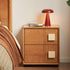 Natural solid hardwood bedside table with two drawers and cream handles beside a bed
