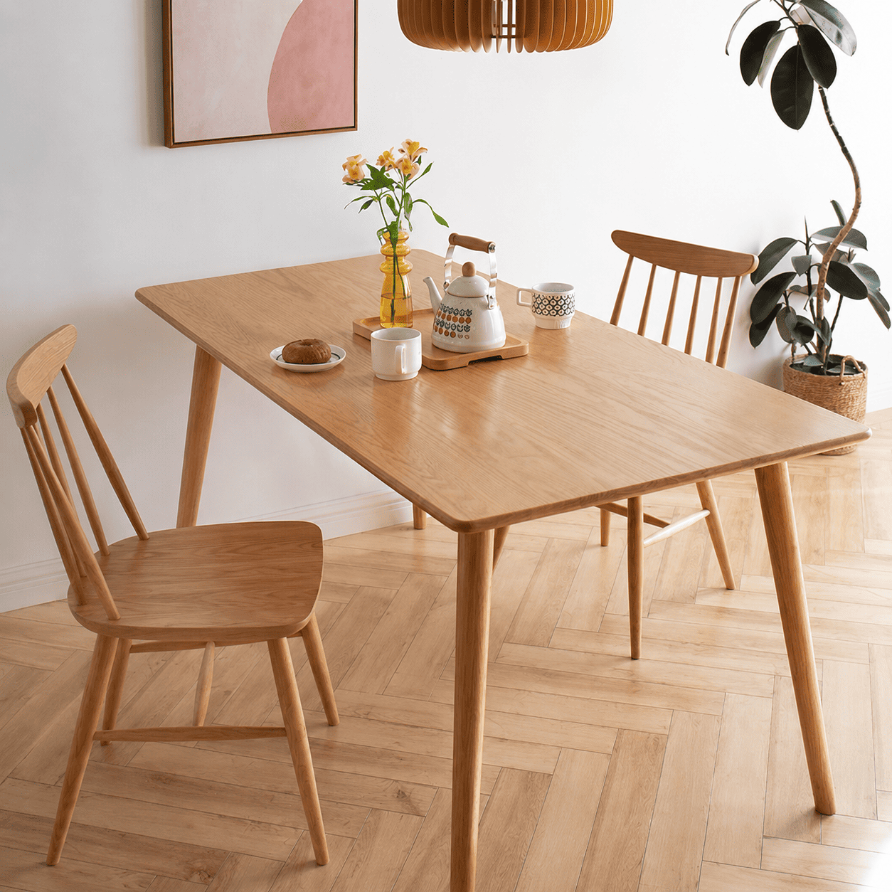 Hasjo Natural Solid Ash Dining Chair with a spindle back and warm natural wood finish, styled around a matching rectangular dining table in a bright dining room.