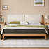 Solid oak bed frame with a cream upholstered headboard and minimalist contemporary design