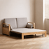 Contemporary wooden sofa bed with a solid oak frame, neutral fabric cushions, and pull-out functionality