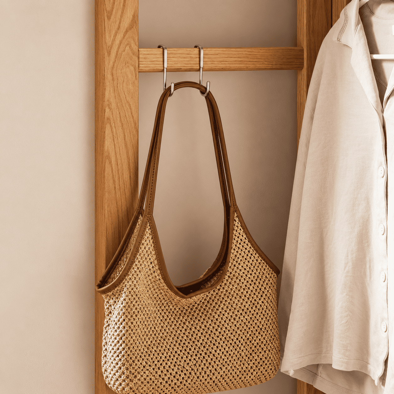 Close up of Kent natural solid oak coat rack side hook with woven shoulder bag