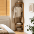 Kent natural solid oak corner coat rack with hanging clothes, bag and folded textiles