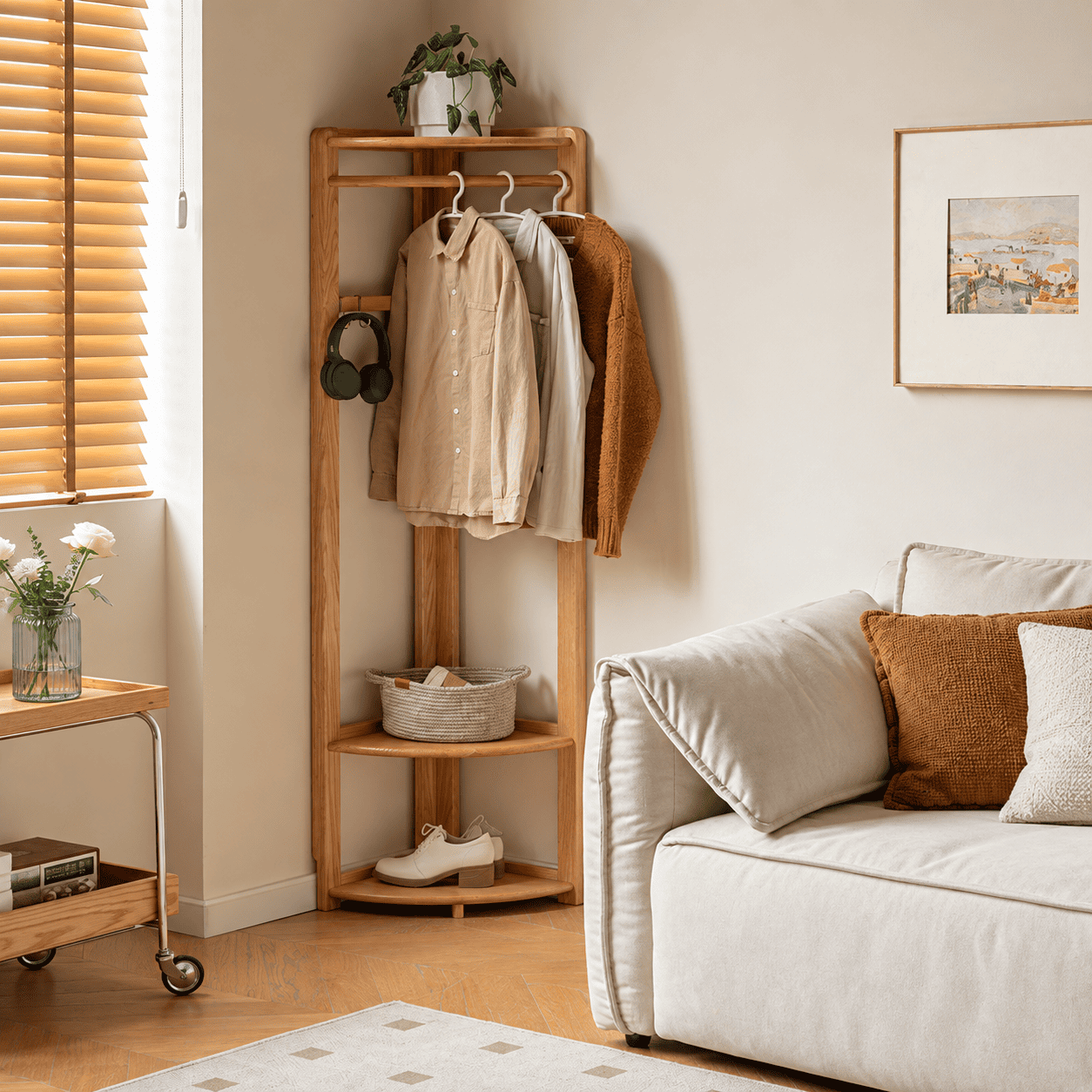 Kent natural solid oak corner coat rack styled in living room with clothes, shoes and storage basket