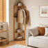 Kent natural solid oak corner coat rack styled in living room with clothes, shoes and storage basket