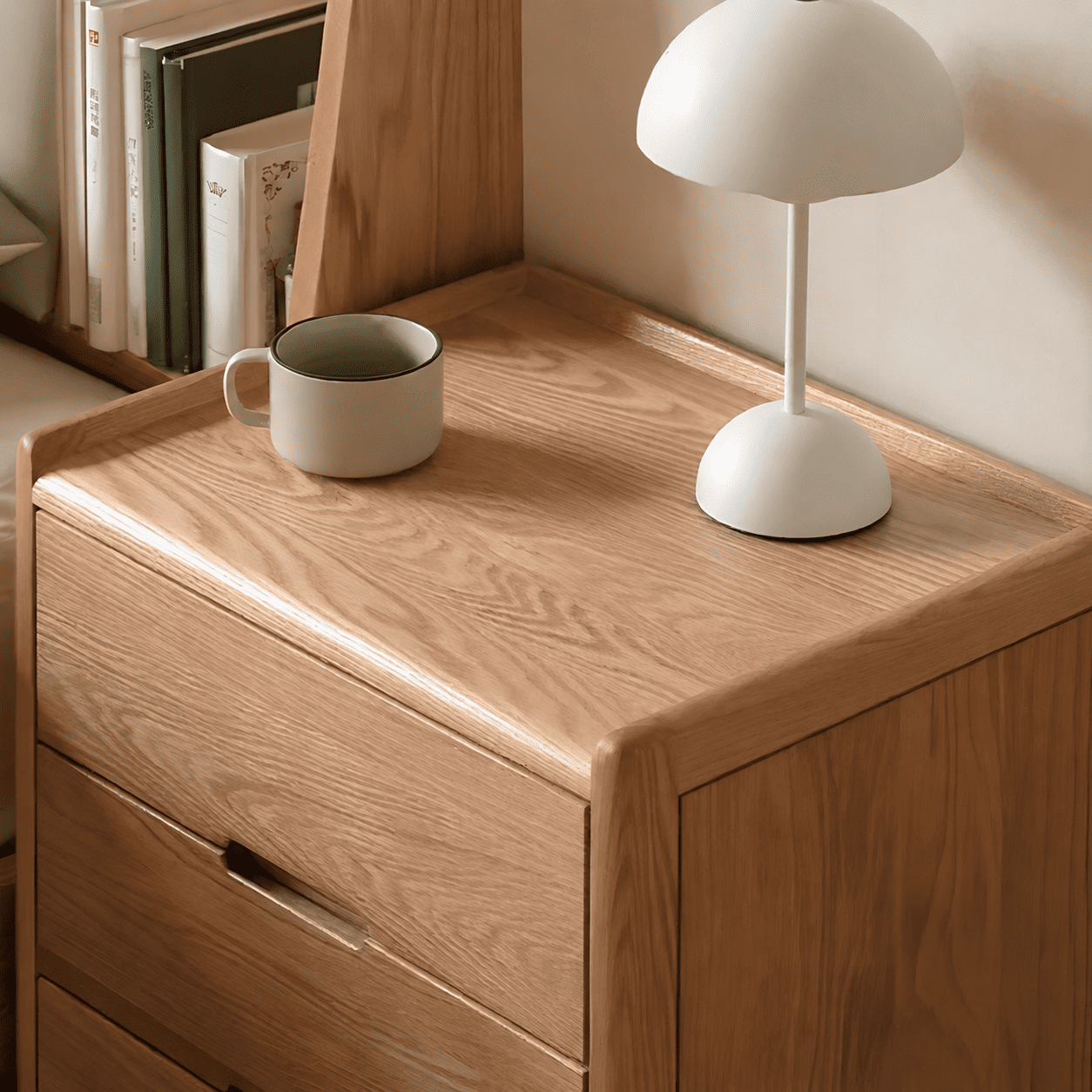 Close-up of Kusel Natural Solid Oak Bedside Table top with raised protective edges, natural oak grain and bedside lamp styling.