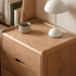 Close-up of Kusel Natural Solid Oak Bedside Table top with raised protective edges, natural oak grain and bedside lamp styling.