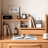 Lathum Natural Solid Beech Desktop Shelf styled on a wooden desk with books, clock, speaker and decorative storage