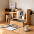 Lathum Natural Solid Beech Desktop Shelf with open drawer, books and study accessories on a warm wooden desktop