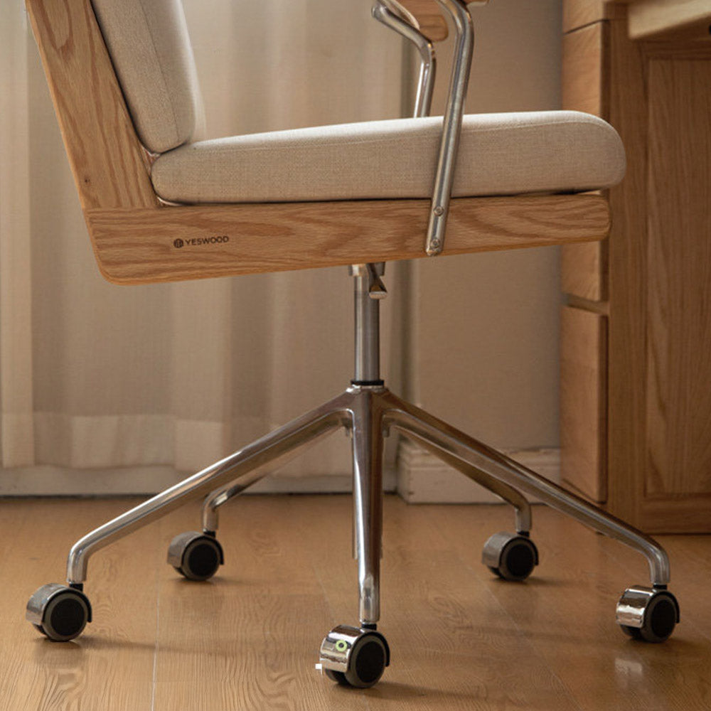 Lecca natural solid oak office chair with warm white fabric cushion and swivel base in a modern home office