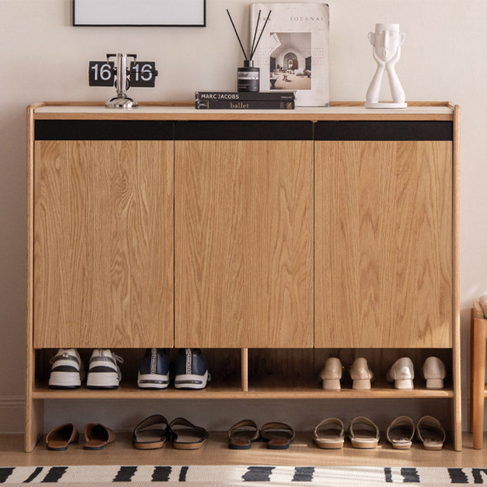 Limina natural solid oak shoe cabinet with white ceramic top, adjustable internal shoe racks and open shoe storage shelves in a hallway