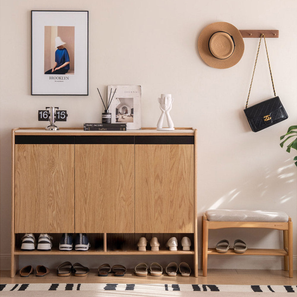 Limina natural solid oak shoe cabinet with white ceramic top, adjustable internal shoe racks and open shoe storage shelves in a hallway