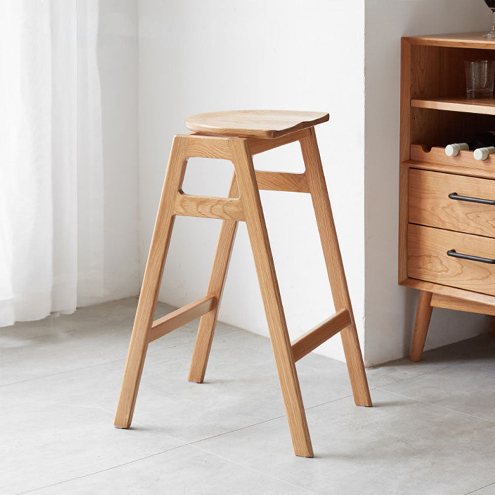 Mergo solid oak bar stool with stackable A-frame design and footrest, shown in natural oak finish with 69.5cm height.
