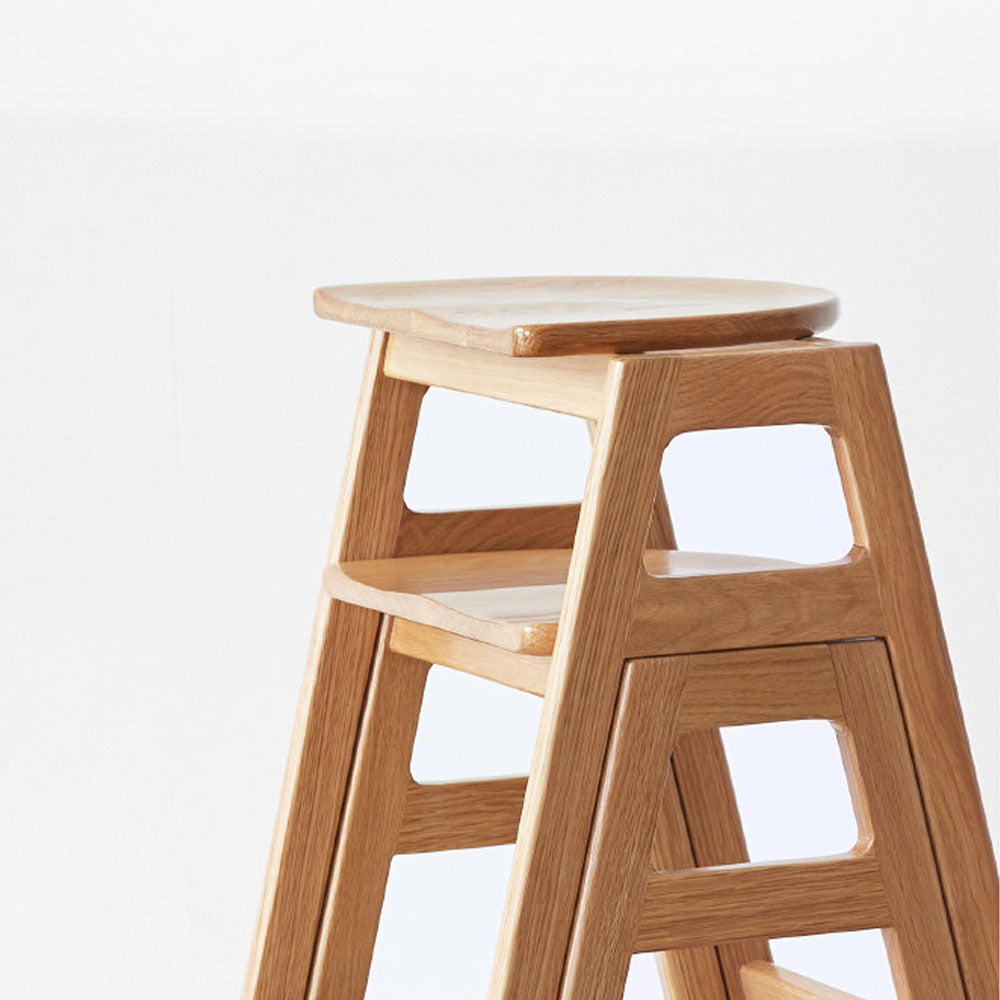 Mergo solid oak bar stool with stackable A-frame design and footrest, shown in natural oak finish with 69.5cm height.