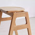 Mergo solid oak bar stool with stackable A-frame design and footrest, shown in natural oak finish with 69.5cm height.