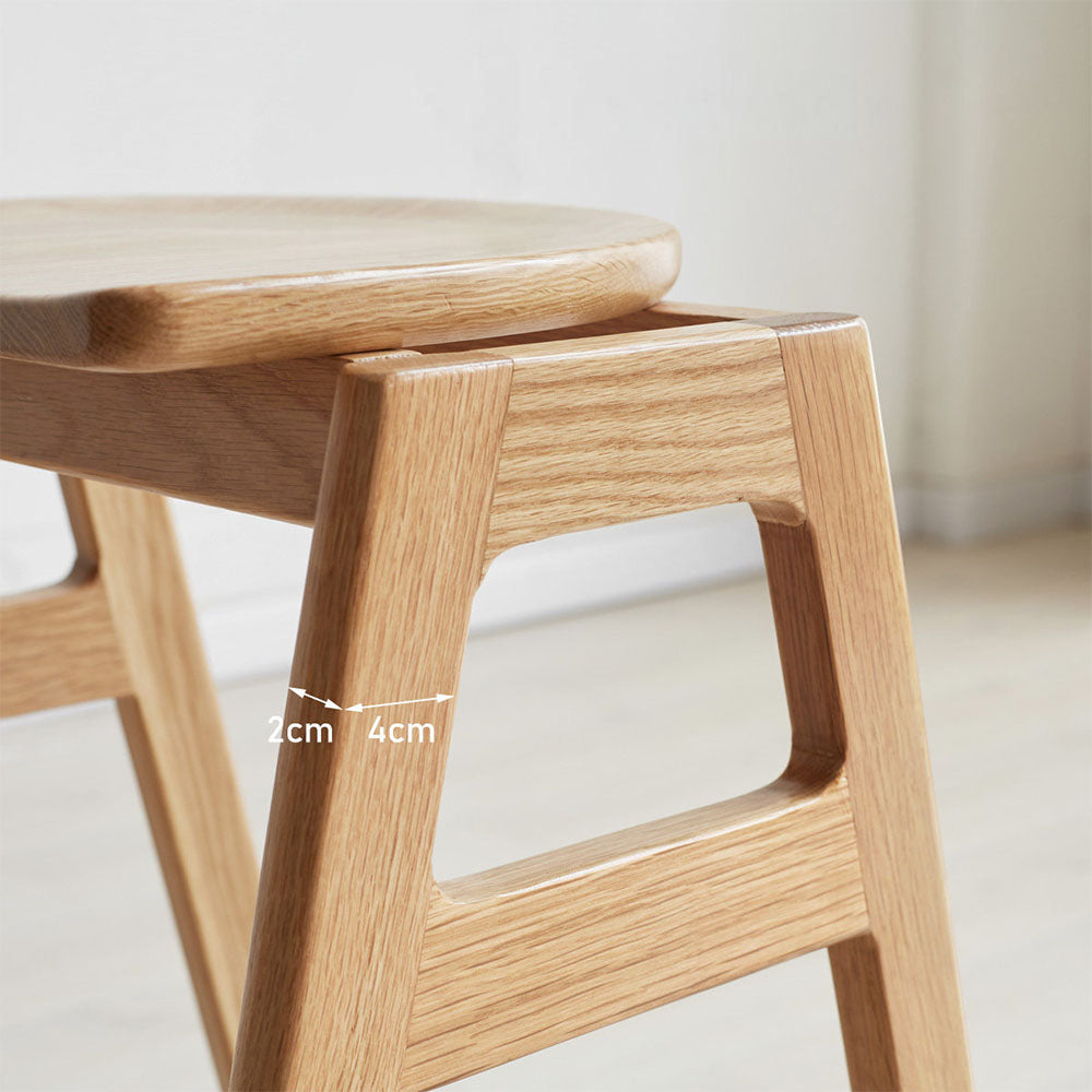 Mergo solid oak bar stool with stackable A-frame design and footrest, shown in natural oak finish with 69.5cm height.