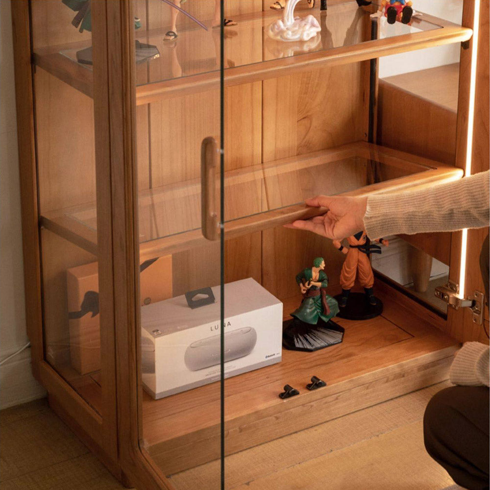 Milis natural solid cherry display cabinet with glass panels and LED lighting in a modern organic Kiwi living room