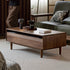 Modena natural solid walnut coffee table with glass-accented drawers and elevated legs in a modern living room setting