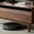 Modena natural solid walnut coffee table with glass-accented drawers and elevated legs in a modern living room setting