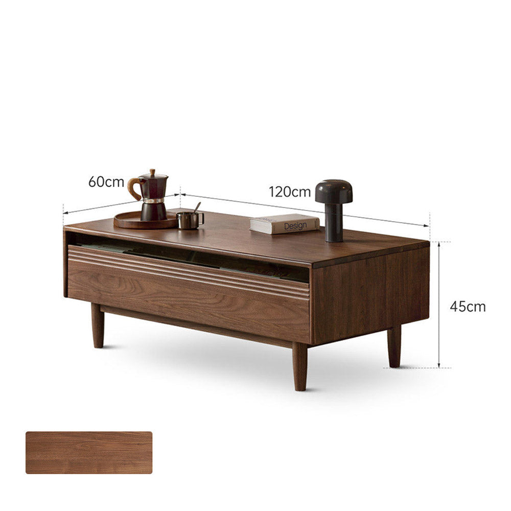 Modena natural solid walnut coffee table with glass-accented drawers and elevated legs in a modern living room setting