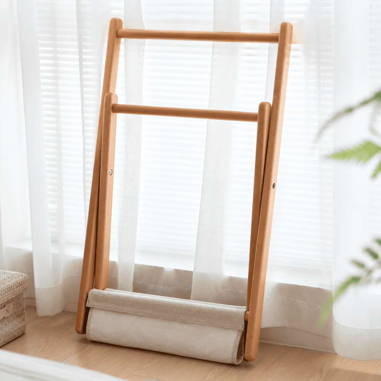 Naila natural solid beech coat rack folded flat beside window