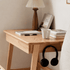 Modern oak bedside table featuring a storage drawer, open leg design, and natural wood finish